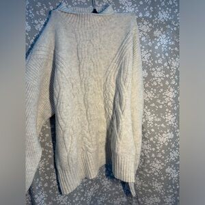 Cream colored short turtle neck wool sweater